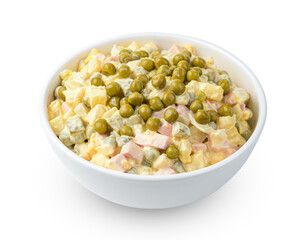 Olivier salad with vegetables, sausage and peas is isolated on a white background. Side view, close-up.