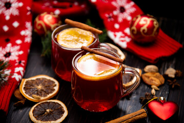 Fruity mulled wine on a wooden background with spices.