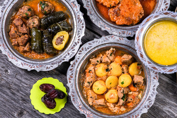 Fototapeta na wymiar Eid Mubarak Traditional Ramadan Iftar dinner. Assorted tasty food in authentic rustic dishes on wooden blue background. Turkish Bosnian food meat kebab, pita, Sarma, klepe, sogan dolma.