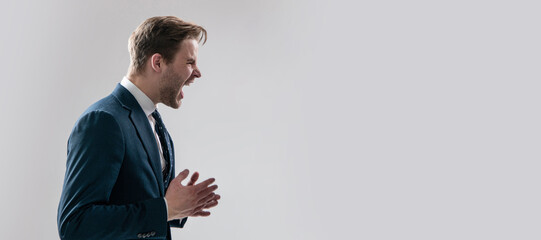 Yelling and screaming. Man face portrait, banner with copy space. Business man in suit, isolated...