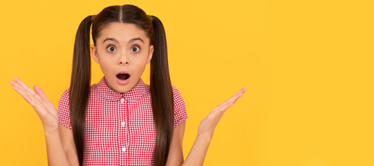 OMG. Surprised child yellow background. Wide-eyed girl got surprised. Surprise and shock. Child face, horizontal poster, teenager girl isolated portrait, banner with copy space.
