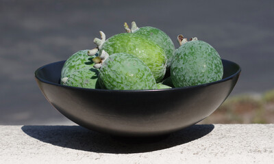 Black bowl with fresh guava fruits