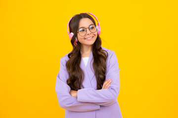 Young teen child listening music with headphones. Girl listening songs via wireless headphones. Wireless headset device accessory.