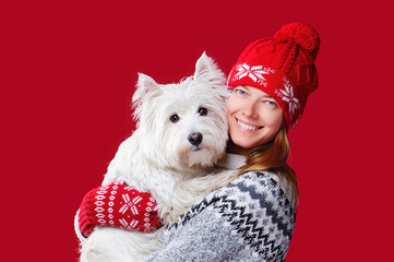 Closeup portrait of a woman in red hat with her white westie dog