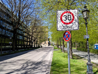 Speed limit road sign on pedestrian city street, zone 30