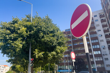 One-way restriction signpost in with residential buildings in the background