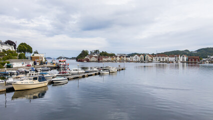 Fototapeta na wymiar Farsund, Norway - View at the waterfront of the idyllic village of Farsund in southern Norway