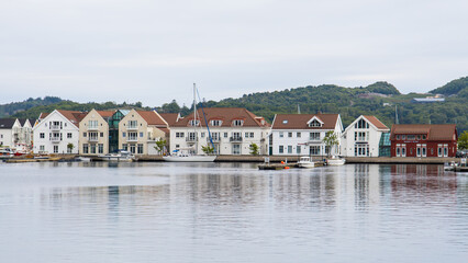 Fototapeta na wymiar Farsund, Norway - View at the waterfront of the idyllic village of Farsund in southern Norway
