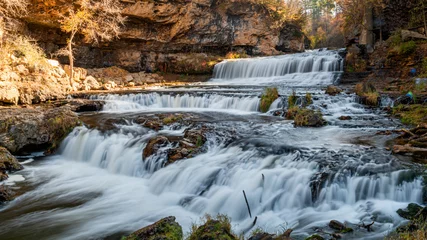 Fototapeten Waterfall at Willow River State Park in Hudson Wisconsin in fall © Yan