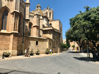 Tarragona, Spain, June 2019 - A large stone statue in front of a building