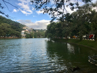 Kandy, Sri Lanka, November 2019 - A body of water surrounded by trees