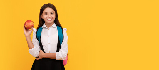 Going back-to-school. Happy child smile holding apple. Horizontal isolated poster of school girl student. Banner header portrait of schoolgirl copy space.