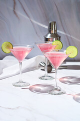 Cosmopolitan cocktail drink served with lime