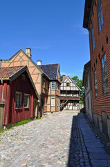 Fototapeta na wymiar Oslo, Norway - Old wooden and brick buildings on Bygdoy peninsula. Norwegian open-air museum in Oslo.