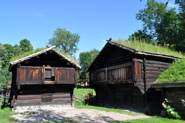 Oslo, Norway - Old wooden houses with grass on the roof at the Norwegian Folk Museum in the city center..