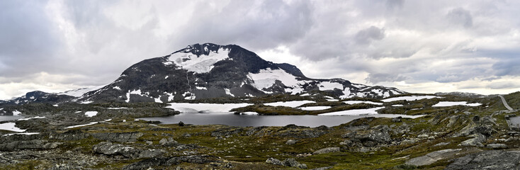 Sognefjell, Jotunheim, Norway - rocky landscape with snow in a natural park. Snow-covered rocks, mountains and icy lakes.