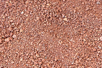Red volcanic stones soil texture in National Park of Timanfaya - Lanzarote - Spain