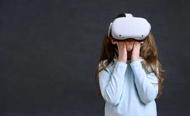 Kid in metaverse, child uses virtual reality headset for new experience