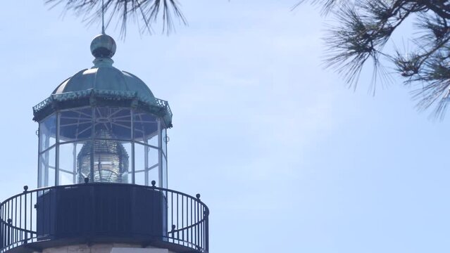 Vintage lighthouse tower, retro light house, old fashioned historic classic white beacon with fresnel lens. Nautical navigational coastal building 1855. Point Loma, Cabrillo, San Diego, California USA