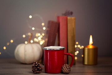 BOOKS AND COFFEE WITH MARSHMELOVES. DRY LEAVES IN AUTUMN,romantic books, peace photo dry leaf, in dim light, ornamental pumpkins, old books, yellow leaves, peace and relaxation corner