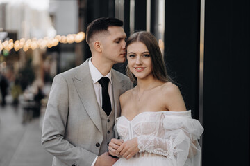 Happy couple having wedding phtoshoot outdoors.