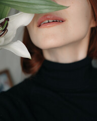 the girl smiles. white lily flower