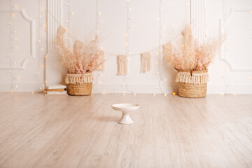 Card. Stylish photo zone. Light background, white wood floor. Сake smash concept.