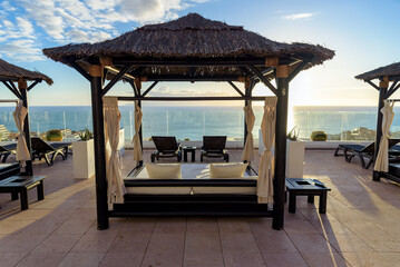 Balinese beds on a terrace with ocean view