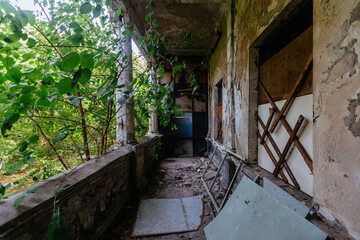 Old overgrown balcony of abandoned mansion