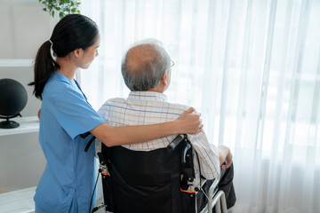 Rear view of a caregiver and her contented senior man gazing out through the window. Elderly health...