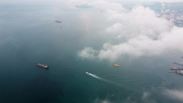 Aerial view yellow roro ship in morning low cloud