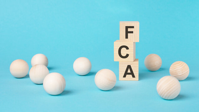 Fca - Short For Financial Conduct Authority - On A Wooden Cubes On A Blue Background