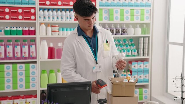 Young hispanic man pharmacist scanning pills at pharmacy