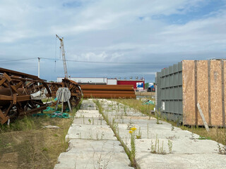 A large outdoor warehouse at a construction site, a warehouse for industrial equipment and materials in boxes at an open-air storage site