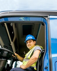 Caucasian man driver wearing helmet and safety vest and sitting on driving seat of truck