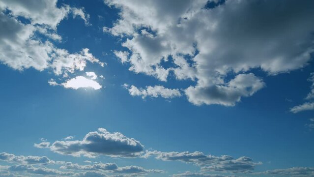 Building clouds and sun rays breaking through cloud mass. Flares shinning through dramatic clouds. Timelapse.