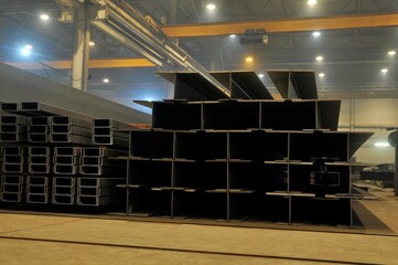 Warehousing in the workshop at the plant stock of metal I-beams profile pipes.