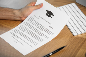 Obraz premium Student with acceptance letter from university at wooden table indoors, closeup