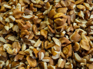 Peeled Georgian nuts. Background of nuts without shells. Snack on the table. Squirrel food. Lots of nuts. Hearty ingredient. Tasty food. Market stall. Choice of ingredients for cooking. 