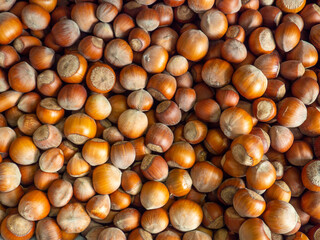 Lots of hazelnuts. Background from unpeeled walnut. Hazelnut pattern. Market stall. Selection of ingredients in the market. Healthy food.