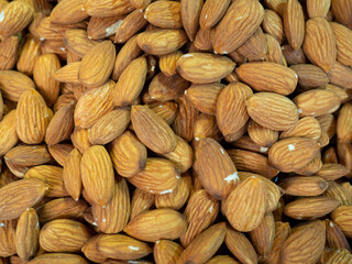 Almond nuts. Background of nuts without shell. Snack on the table. Peeled nuts. Hearty ingredient. Tasty food. Market stall. Choice of ingredients for dinner. Healthy food.