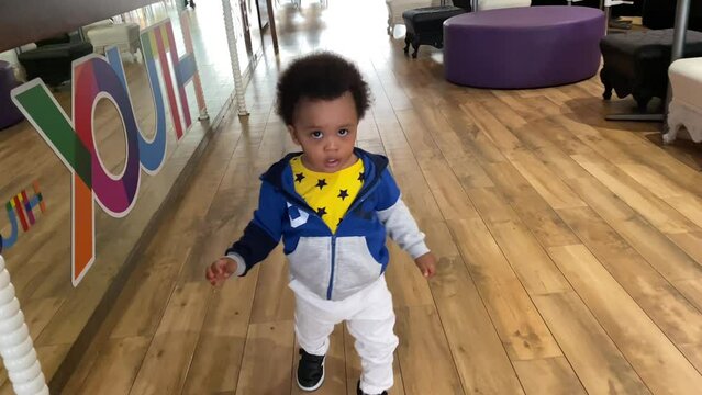 Lovely one year old black baby first walk indoor