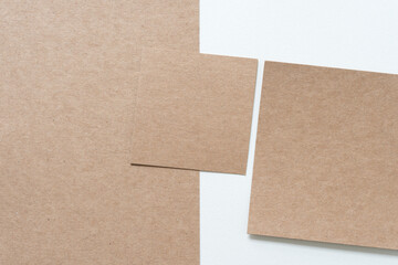 Fototapeta premium plain brown paper cardboard shapes on blank paper