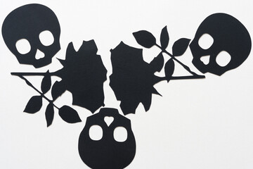 black paper skull heads and roses in silhouette