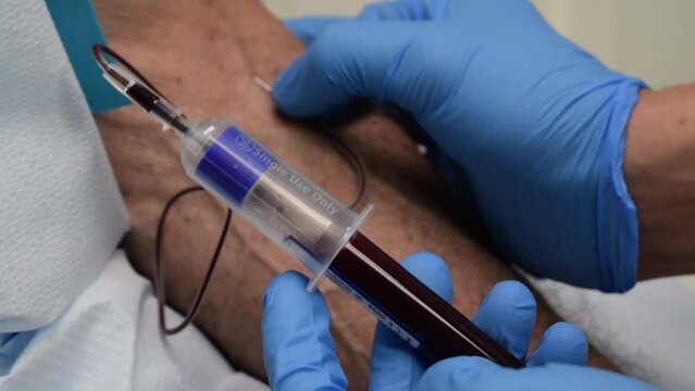 Doctor taking a blood sample from the patient  - concept of PRP injections and testing