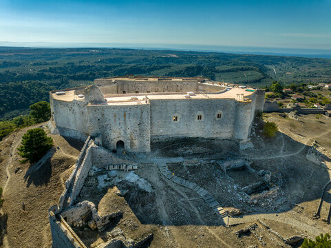 Aerial view of Chlemoutsi castle medieval hilltop fortress of the French knights in Greece with stormy sky