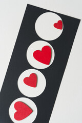 wooden heart painted red and black paper stencil with circle cutouts