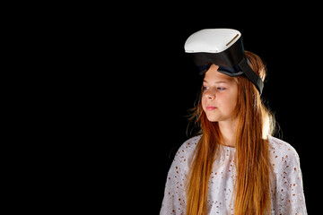 vr goggles and girl. Young woman in white shirt and jeans wearing virtual goggles. Woman standing with folded hands. Cyber technology and new virtual reality. metaverse and young generation banner on