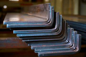 Long bent metal details stacked at production plant