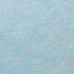 background with tissue paper and blue paper with dots beneath